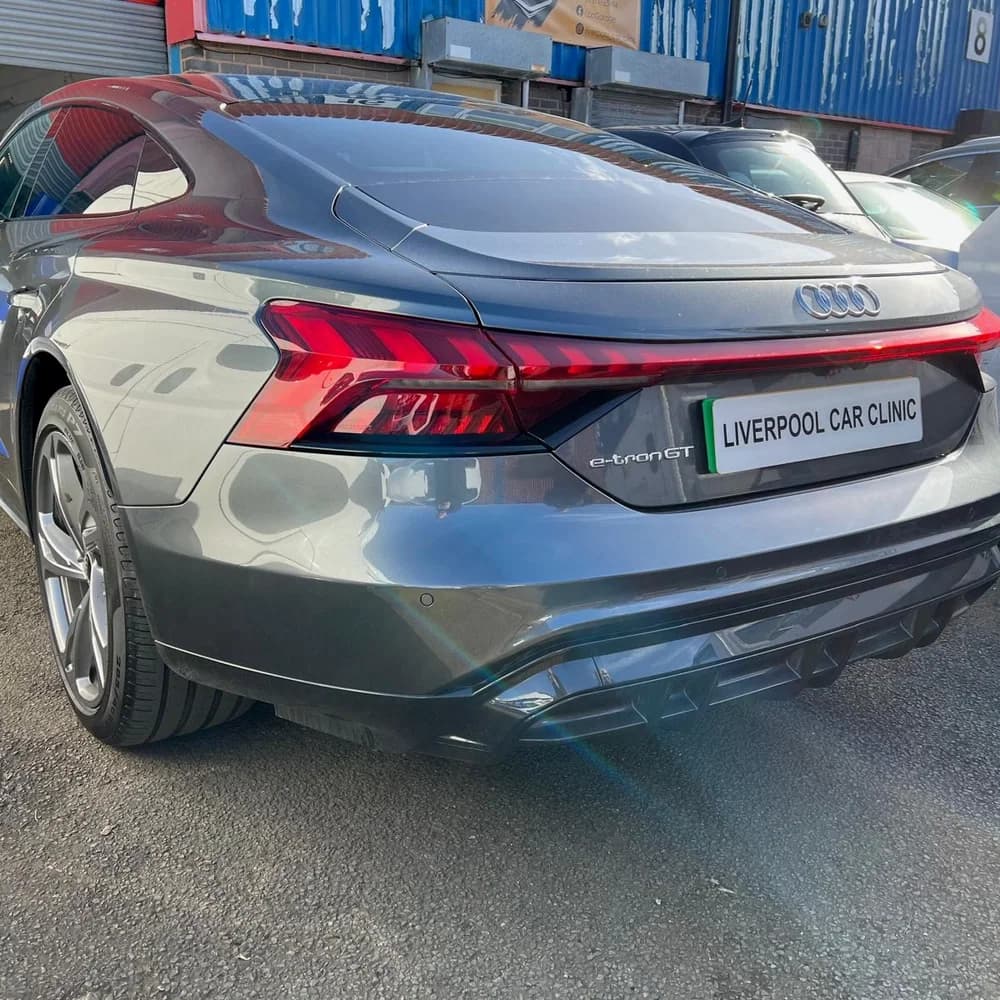 The rear of a grey Audi e-tron GT carrying a Liverpool Car Clinic trade plate.