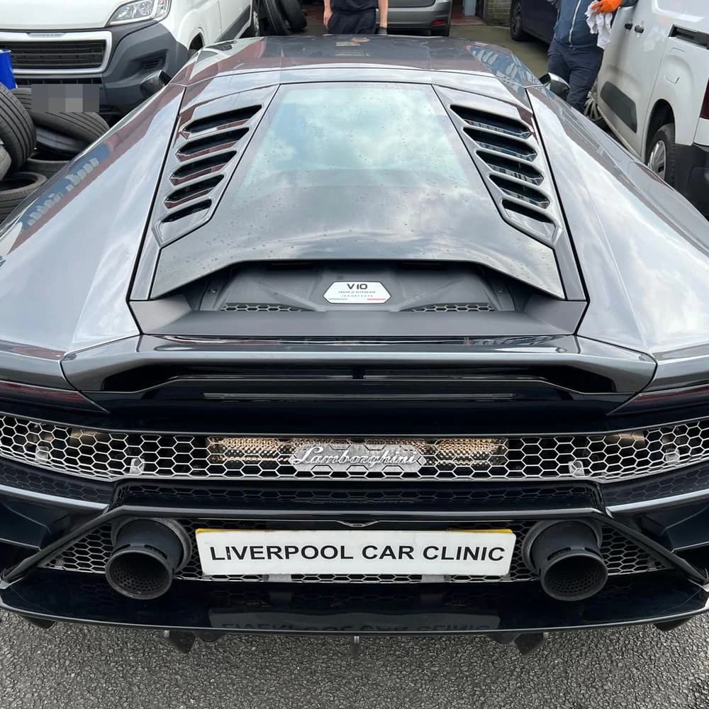 The rear of a grey Lamborghini Huracan carrying a Liverpool Car Clinic trade plate.